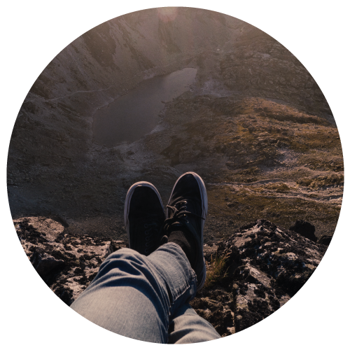 person resting on summit of mountain